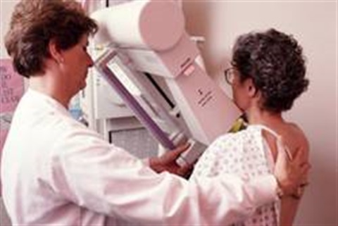 Doctor with a patient doing a cancer mammogram 